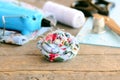 Floral textile brooch. Boho flower brooch decorated with beads, hot glue gun, scissors, thread spool, thimble, felt sheet Royalty Free Stock Photo