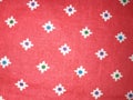 Floral texture on red coloured cloth