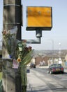 Floral tributes tied to lamp post near accident in front of speed camera