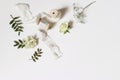 Floral wedding, birthday table composition. Gypsophila, rose flowers, green lentisk leaves and silk ribbons with wooden