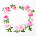 Floral wreath frame made of pink roses and peonies with green leaves on white background. Flat lay, top view. Flower background Royalty Free Stock Photo