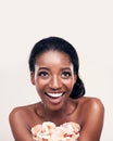 Florally fresh. Studio shot of a beautiful young woman holding a handful of flower petals. Royalty Free Stock Photo