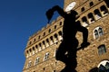 Florence, backlit of Perseus bronzes with Palazzo Vecchio in the background Royalty Free Stock Photo