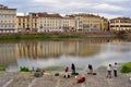 Florence city with tourists enjoying view on the Arno river in Italy Royalty Free Stock Photo