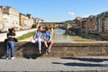 Florence city with tourists enjoying view on the Arno river in Italy Royalty Free Stock Photo