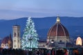 Florence, 12 December 2021: The Cathedral of Santa Maria del Fiore with illuminated Christmas tree and ferris wheel on the right