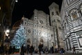 Florence, December 2018: Illuminated Christmas tree with tourists in Piazza del Duomo in Florence.