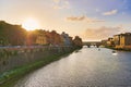 Florence or Firenze, Ponte Santa Trinita medieval Bridge landmark on Arno river and a boat, sunset landscape. Ponte Vecchio on the Royalty Free Stock Photo