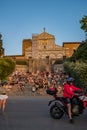 Florence ITALY - August 6, 2023 - Couple on motorbike leaving a staircase full of people