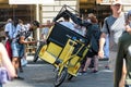 Driver repairs a rickshaw in a crowded square near the Basilica of Santa Maria del Fiore, Florence