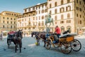 Florence, Italy - August 25, 2020: Horse-drawn carriages with drivers waiting for tourists in Piazza della Signoria Royalty Free Stock Photo