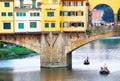 FLORENCE, ITALY, 10 AUGUST 2020: Touristic boats on Arno River near Ponte Vecchio, seen from the Ponte Santa Trinita in Florence.