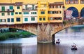 FLORENCE, ITALY, 10 AUGUST 2020: Touristic boats on Arno River near Ponte Vecchio, seen from the Ponte Santa Trinita in Florence.