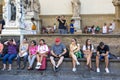 Tourists rest in Piazza della Signoria in Florence