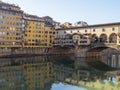 FLORENCE, ITALY, January 6, 2020: The River Arno in winter sunshine. Ponte Santa Trinita bridge looking to San Frediano