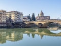 FLORENCE, ITALY, January 6, 2020: The River Arno in winter sunshine. Ponte Santa Trninita bridge looking to San Frediano