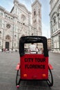 A rickshaw in Santa Maria del Fiore square. Tourists guide waiting for customers..