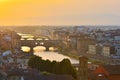 Florence, Italy - July 19, 2017: View of the River Arno and famous bridge Ponte Vecchio. Amazing evening golden hour light. Royalty Free Stock Photo