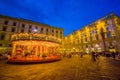 FLORENCE, ITALY - JUNE 12, 2015: Carousel at night iluminated in the middle of the square in Florence. Different forms