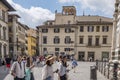 Group of young Chinese women doing tuirsmo in the square called del Duomo and facades of typical houses of the