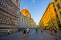 FLORENCE, ITALY - JUNE 12, 2015: Large street on the side of Florence Cathedral, people walking around minutes before