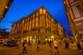 FLORENCE, ITALY - JUNE 12, 2015: Nice square building at night in Florence, historic center iluminated. People walking