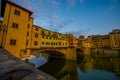 FLORENCE, ITALY - JUNE 12, 2015: Nice water view with buildings shadows on Florence, Old bridge or Ponte Vecchio