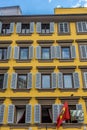 Florence, Italy - 25 June 2018: Scuderia Ferrari Scarlet Tifosi flag flying against a window in Florence, Italy Royalty Free Stock Photo