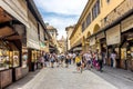 Florence, Italy - 25 June 2018: Tourists walking over the Ponte Vecchio bridge over the Arno River in Florence, Italy