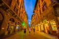 FLORENCE, ITALY - JUNE 12, 2015: Unidentified turists walking on Florence at night, shops are open with a holding blue