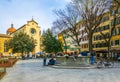 FLORENCE, ITALY, MARCH 15, 2016: a group of young people is sitting on a fountain in front of the church santo spirito