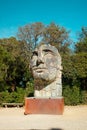 Florence, Italy - March 16 2023: Side view of the enormous bronze face sculpture Tindaro Screpolato by famous artist