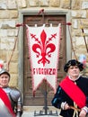 Traditional Florentine guards with flag posing in front of tourists