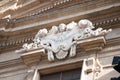 Ornate sign decorates a doorway in Florence, Italy.