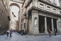 Tourists walking by the Uffizi Gallery, an art museum in Florence, Italy