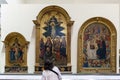 Visitor to the Gallery of the Academy of Florence looking at the three paintings