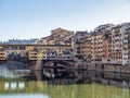 Florence in Italy in winter sunshine. The River Arno and part of the famous Ponte Vechio, Old Bridge, with Royalty Free Stock Photo