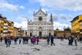 Florence, Tuscany, Italy - March 31, 2018: Tourist walking on the square in the historical center. The Basilica di Santa Croce, Royalty Free Stock Photo