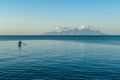 Flores/Indonesia 20290808: A fishermen`s boat crossing a calm sea near Maumere, Indonesia There are three men in one small, blue