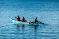 Flores/Indonesia 20290808: A fishermen`s boat crossing a calm sea near Maumere, Indonesia There are three men in one small, blue