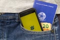 Florianopolis, Brazil. June 27, 2020: Close up of cellphone, Work brazilian card and cash in trouser pocket. Brazil Bank screen
