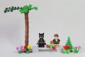 Florianopolis, Brazil. September 19, 2020: Minifigure of Batman giving a bouquet of flowers to Cat Woman in a forest garden on