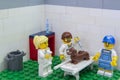 Florianopolis, Brazil. September 19, 2020: Vet minifigure giving injection to a Dachshund dog while a nurse distracts him with a