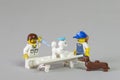 Florianopolis, Brazil. September 19, 2020: Vet minifigure giving injection to a sick Poodle dog while its owner and another dog