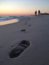 Florida Beach Sunset with People and Footprints in Sand Royalty Free Stock Photo