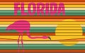 A Florida tourism sign with a flamingo and sunset is seen on a wall