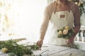 Florist arranging a bouquet of roses in her flower shop Royalty Free Stock Photo