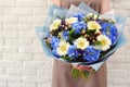 The florist with a beautiful bouquet of flowers hands.