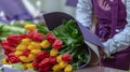 The florist collects a bouquet of tulips