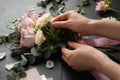 Florist creating beautiful bouquet at black table, closeup Royalty Free Stock Photo